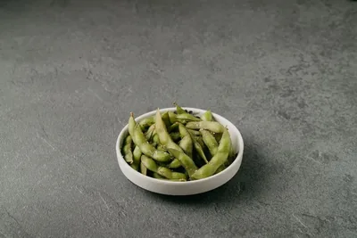 A bowl of salted edamame beans.