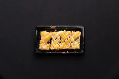 A box of grilled crab nigiri sushi.