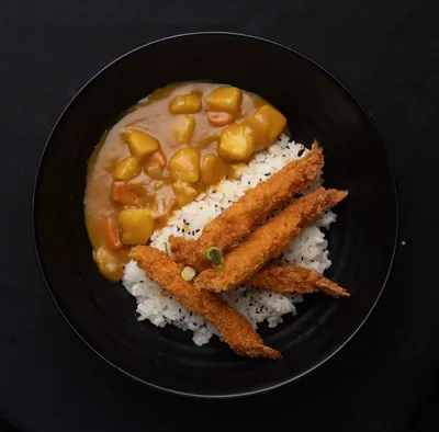 Prawn curry with crumbed prawns and rice.