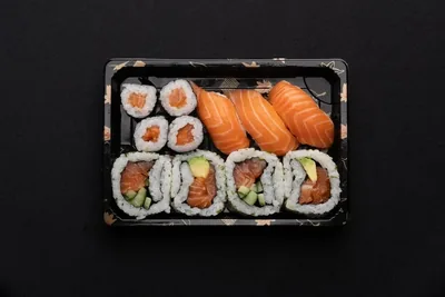 Salmon sushi box with nigiri, maki and rolls.