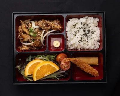 Teriyaki chicken bento box with rice and vegetables.