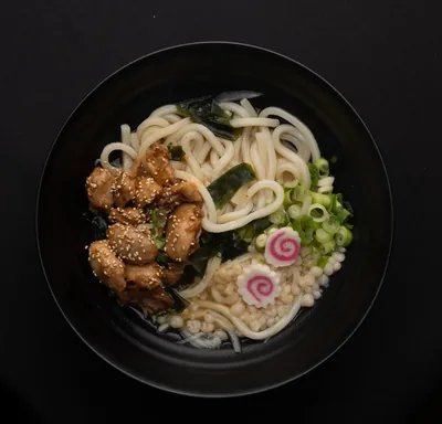 Teriyaki chicken udon soup with wakame and narutomaki.