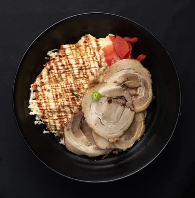 Tonkotsu pork donburi with sliced chashu and rice.