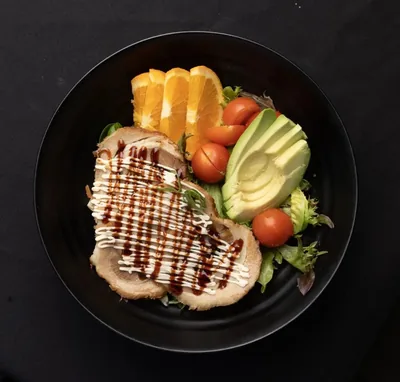 Tonkotsu pork salad with avocado and orange.